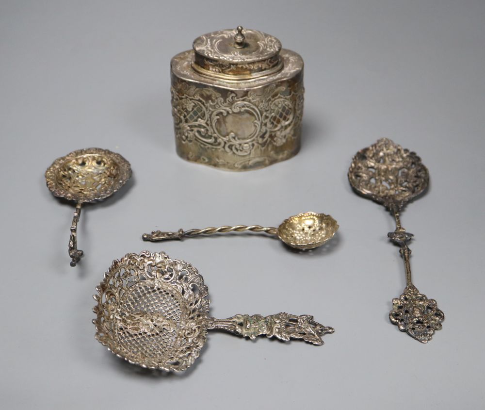 A Dutch oval silver tea caddy, embossed with cherubs and scrolls, 1893 import marks and four sifter spoons, various 5.5oz (caddy)